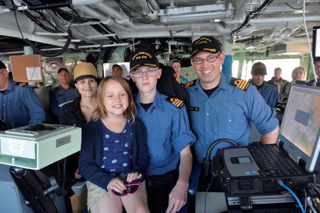 Honorary Captain for a day, Cdr Odin Camus, poses with family and Cdr Kristjan Monaghan, CO of HMCS Montréal.