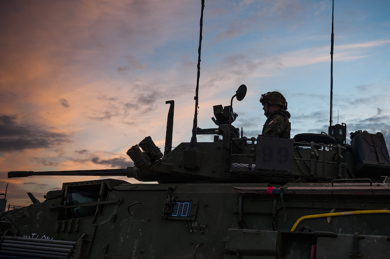 A member of the multinational brigade from 5 Canadian Mechanized Brigade-Group sits in the turret of a Light Armoured Vehicle III, in Santa Margarida, Portugal, during JOINTEX 15 as part of NATO’s exercise Trident Juncture 15 on October 30, 2015. Photo: Sgt Sebastien Frechette VL06-2015-382-16