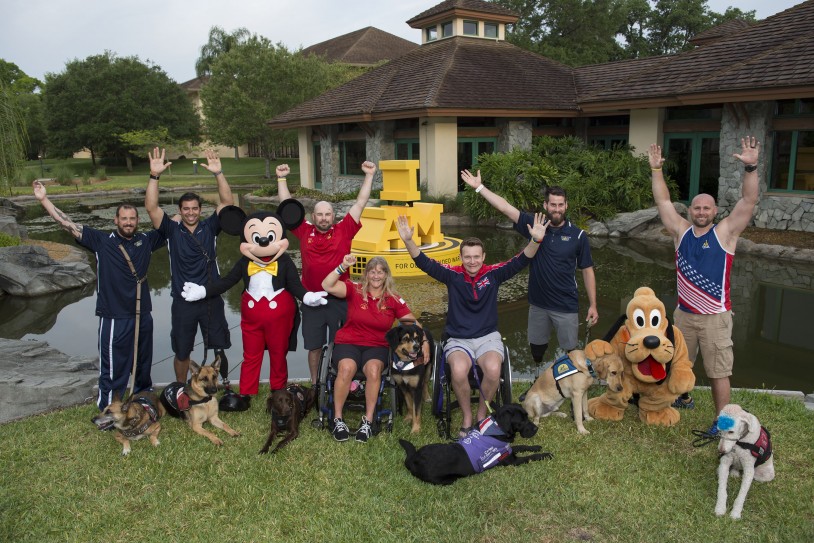 Competitors, their service dogs and Disney’s Pluto the Pup gathered at the competitor village. (Photo courtesy Invictus Games Orlando)