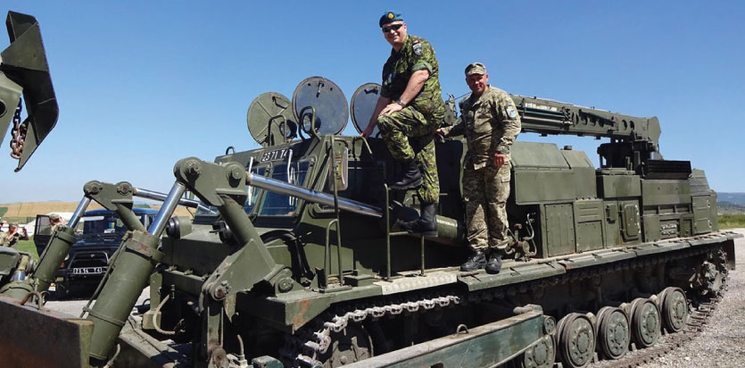 LCol Lefebvre can be seen along with UKR Maj Burnov on a UKR Engineering tank that is used by JLSG for Freedom of Movement tasks as well as for engineering tasks. (Photo: AUT Col Staudacher)