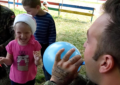 Corporal Francis Nadeau amuses the children during a visit of Joint Task Force – Ukraine personnel to the Dzherelo Rehabilitation Centre on July 27, 2016 in Lviv, Ukraine. Photo by : Capt J.P. Coulombe, Joint Task Force – UkraineDC