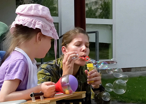 Captain Marie-Claude Otis amuses the children during the visit of Joint Task Force –Ukraine personnel to the Dzherelo Rehabilitation Centre on July 27, 2016 in Lviv, Ukraine. Photo by : Capt J.P. Coulombe, Joint Task Force – Ukraine