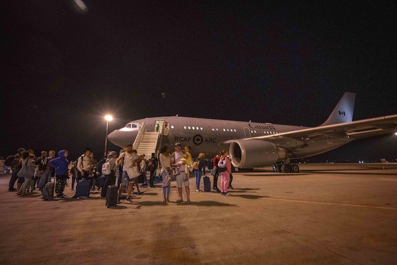 Members of 437 Transport Squadron help with the assisted departure of evacuees from Tel Aviv, Israel to Athens, Greece as part of Operation ION on 15 October 2023. Photo by: Corporal Charles Audet, Canadian Armed Forces Photo. 